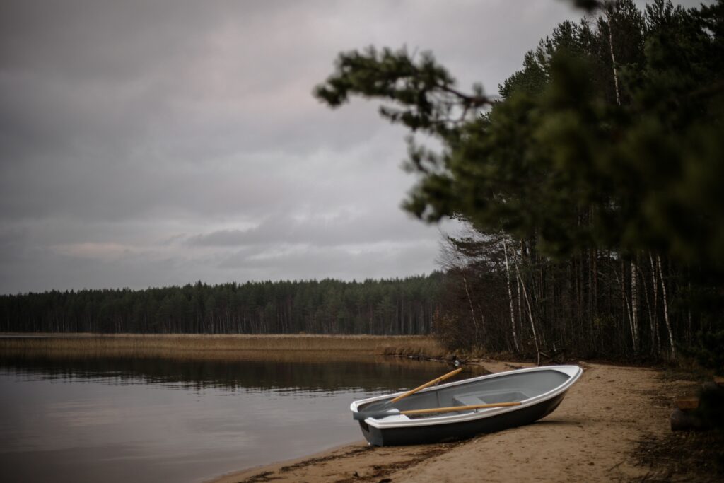 Row boat on lake shore