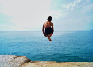 Boy jumping in the sea