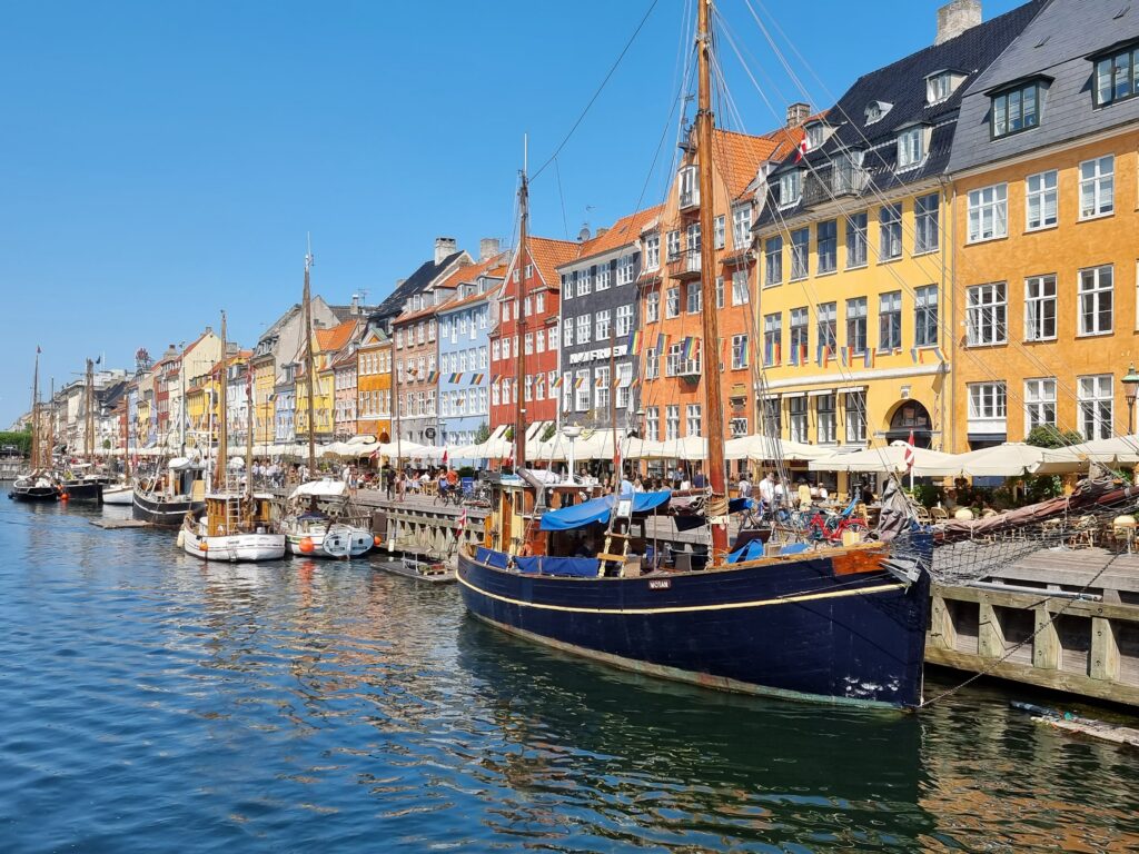 Boats on Dock on a Canal Near Colorful Buildings